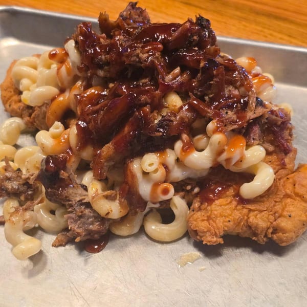 The Bayou Cajun Smokehouse's fried chicken topped with macaroni and cheese, pulled pork, and BBQ sauce.